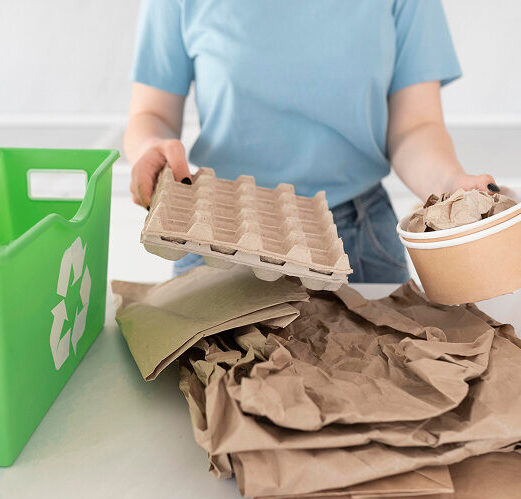 Woman sorting out paper recycling to go into green recycling bin.
Keyword: Packaging